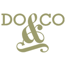 The DO & CO logo displayed in olive‑gold serif lettering, with the words DO and CO separated by a large stylized ampersand that forms an elegant decorative shape, all set against a white background.